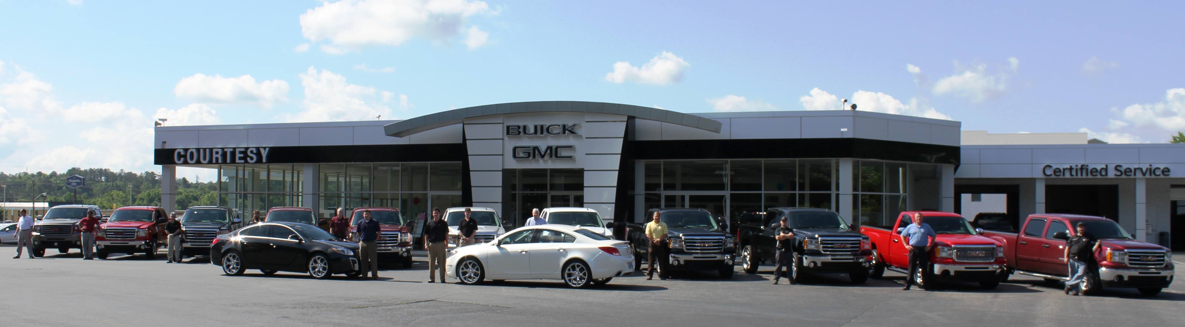 Courtesy GMC Building with team and cars